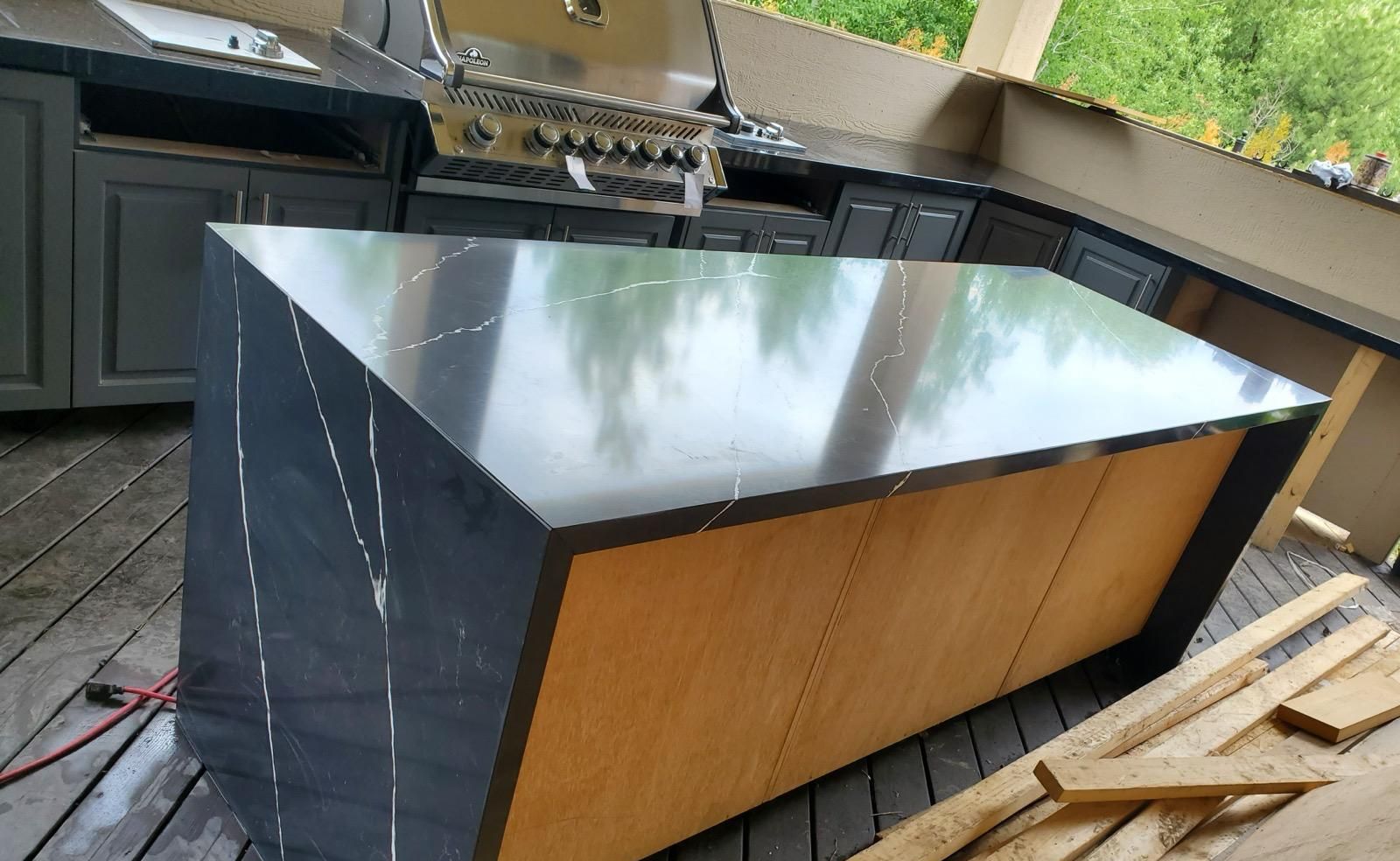 Black waterfall-edge island with white veining