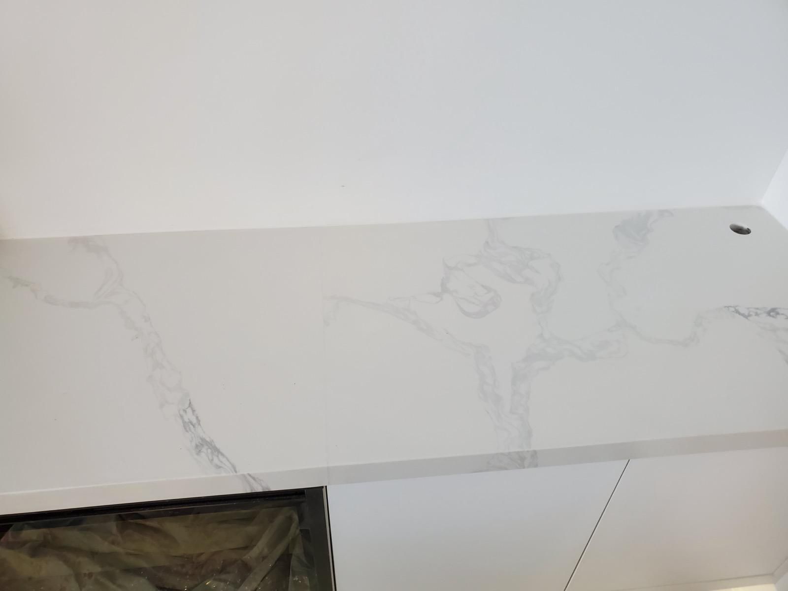 Close-up of veining on a white stone fireplace ledge