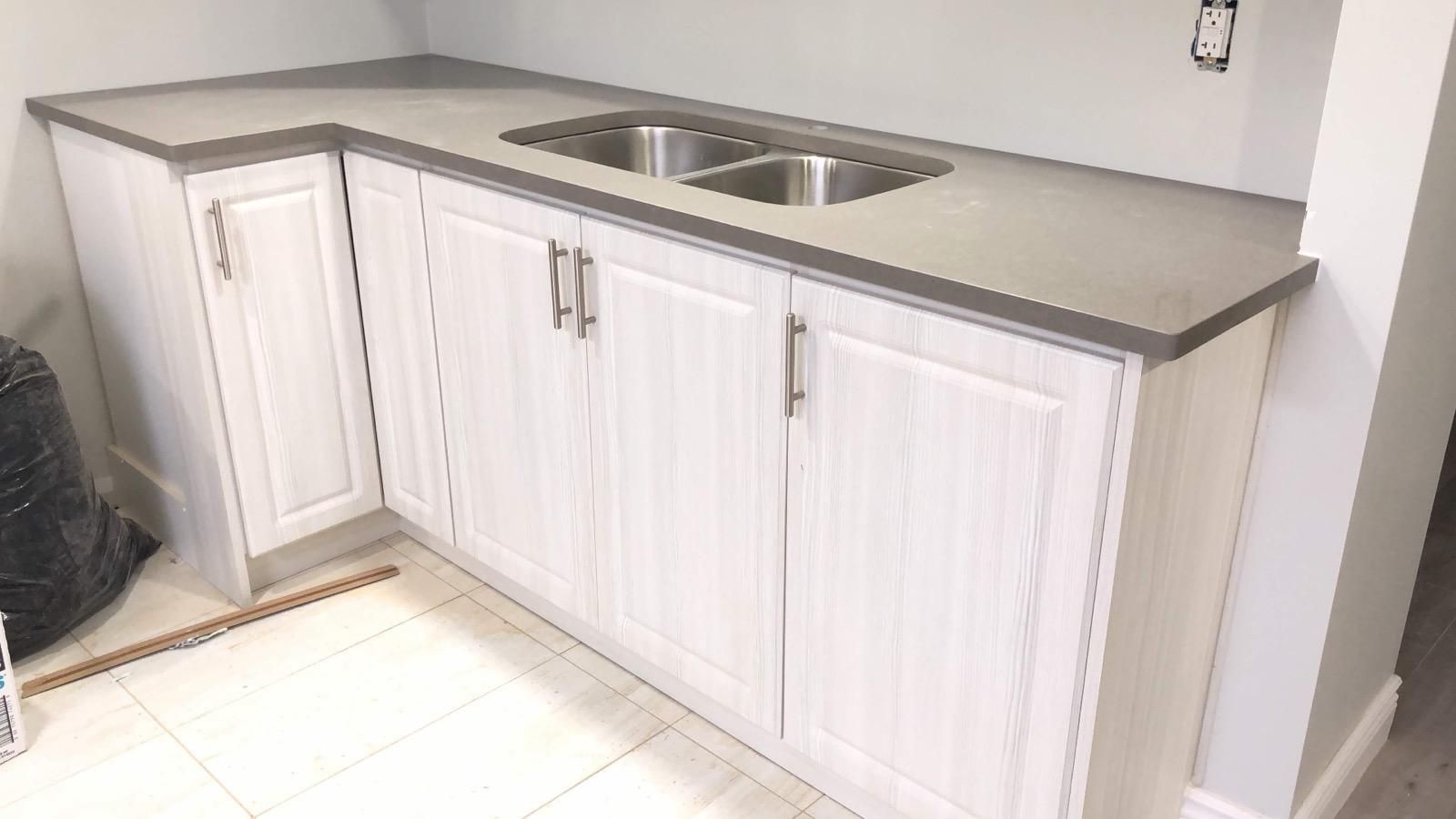 Grey L-shaped countertop with a double sink