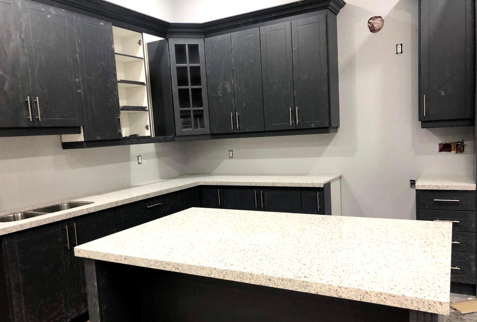 Kitchen island with a white speckled countertop