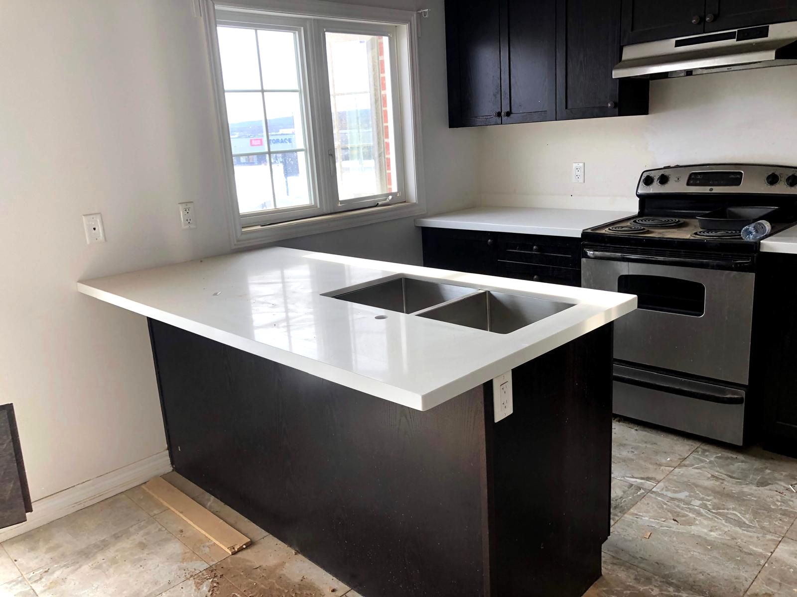 Kitchen peninsula with a white countertop and double sink