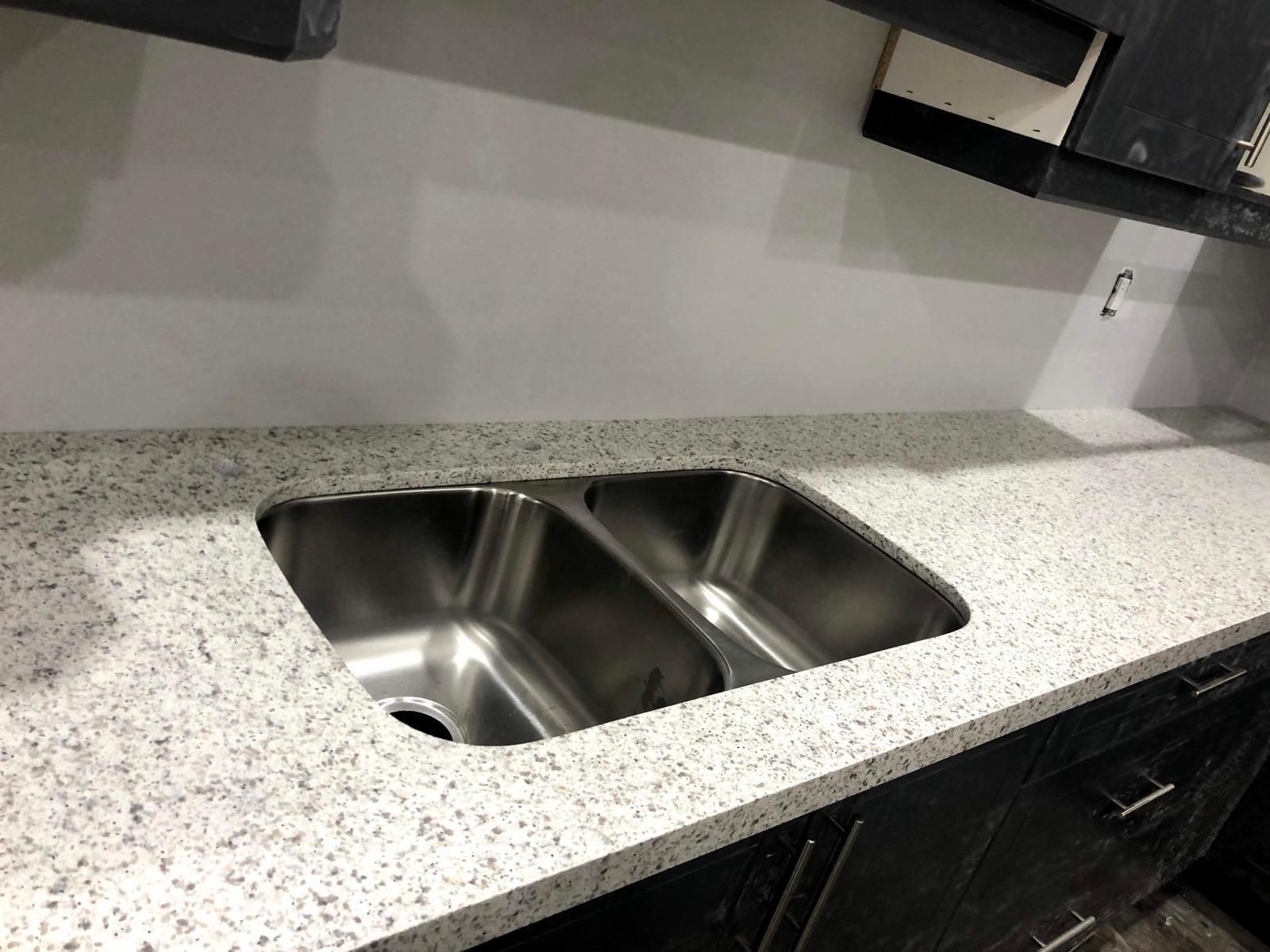White speckled countertop with a double undermount sink